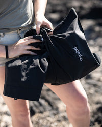 Female outdoors packing Tech-Lite Dryrobe®