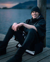 *MALE*  sitting by lake wearing Tech-Lite Dryrobe®