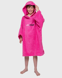 Boy smiling wearing Kids Towel Poncho in Pink, with hood up