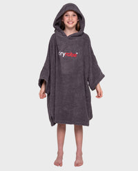 Girl smiling wearing Kids Towel Poncho in Slate Grey with hood up