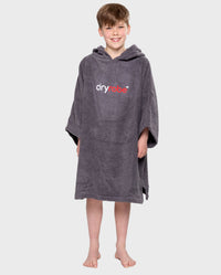 Boy smiling wearing Kids Towel Poncho in Slate Grey