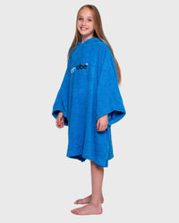 Girl wearing Cobalt Blue Kids Organic Towel poncho
