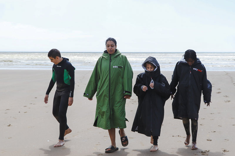 Children on the beach with Omie Dale during the filming of Finally I Sea