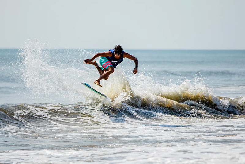 Skimboarder doing an air 