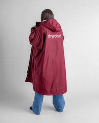 Female in studio wearing AW25 Burgundy Dryrobe® advance long sleeve 