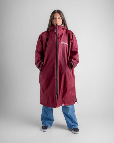 Female in studio wearing AW25 Burgundy Dryrobe® advance long sleeve 