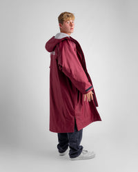 *MALE* in studio wearing AW25 Burgundy Dryrobe® advance long sleeve 