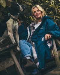 Woman outdoors with dog wearing AW25 Blue Dryrobe® advance long sleeve 