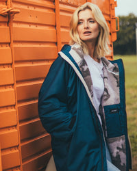 Woman outside in field wearing AW25 Blue Dryrobe® advance long sleeve 