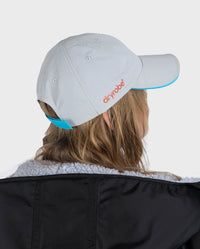 Woman in studio wearing grey Dryrobe® water resistant cap 