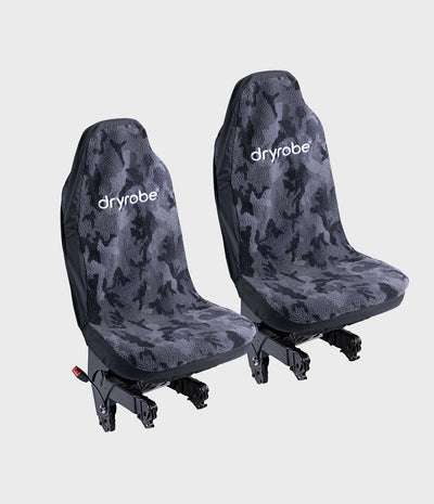 Two Dryrobe truck cab seat covers with a dark gray and black camouflage pattern, shown on vehicle seats against a light gray background.