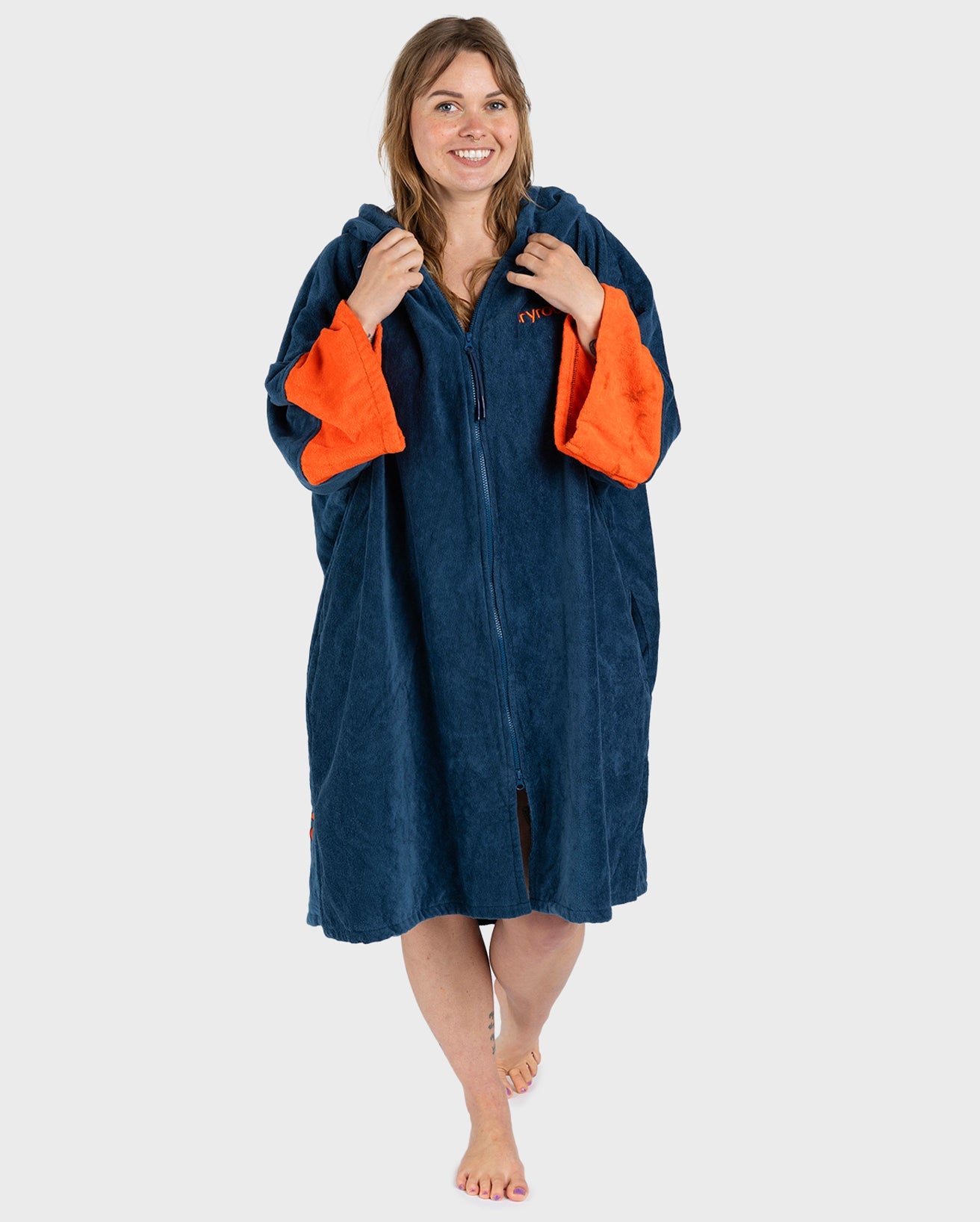 Female in studio wearing Dryrobe® Zip towel (blue orange)