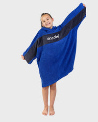 Child wearing Kids Organic Towel dryrobe - Remix in Royal Blue Navy holding arms out 