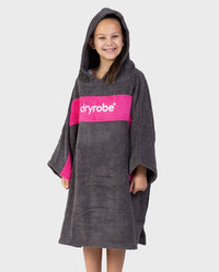 Girl wearing Kids Organic Towel dryrobe - Remix in Slate Grey Pink with hood up 