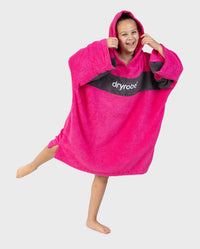 Child wearing Kids Organic Towel dryrobe - Remix in Pink Slate Grey standing on one leg 