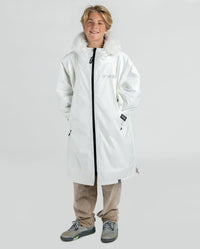 Boy smiling wearing dryrobe Advance Long Sleeve Alpine Range changing robe in Alpine White 