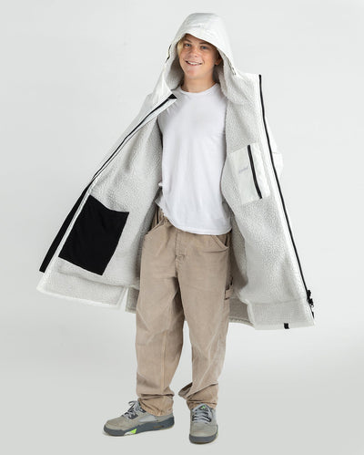 Boy wearing dryrobe Advance Long Sleeve Alpine Range changing robe in Alpine White showing the inner lining