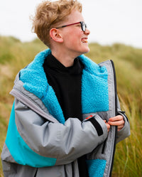 Kid on sand dunes wearing LTD edition 2025 RNLI Dryrobe® Advance long sleeve