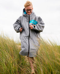 Kid running on sand dunes wearing LTD edition 2025 RNLI Dryrobe® Advance long sleeve