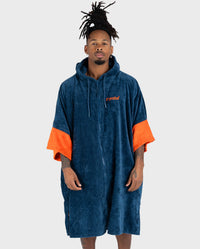 *MALE* in studio wearing Dryrobe® Zip towel (blue orange)