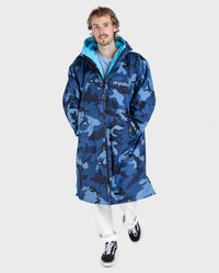 **MALE** Man walking toward 
camera wearing dryrobe Advance Long Sleeve changing poncho in Blue Camo Blue