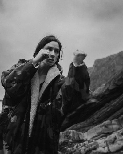 Person in a dryrobe with a mountainous background