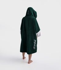 Person wearing a green hooded towel with 'dryrobe' branding on a white background