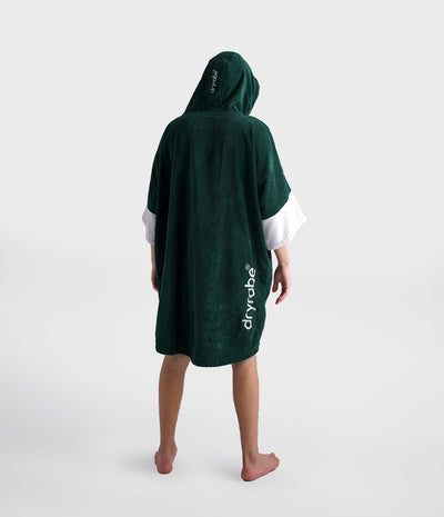 Person wearing a green dryrobe on a white background