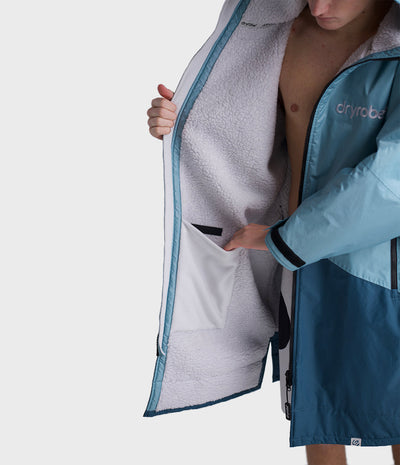 *MALE* Person wearing a blue and gray Dryrobe with 'Dryrobe' branding on a white background
