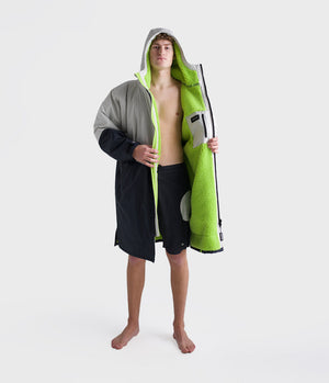*MALE* Person holding a green and grey Dryrobe with a hood on a white background