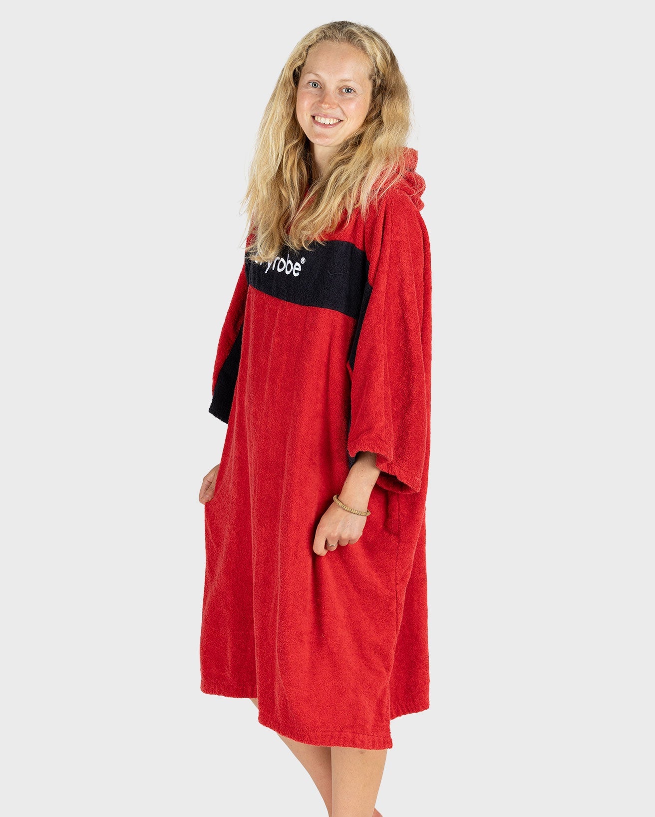 Woman smiling at the camera wearing Organic Towel dryrobe Remix in Red Black