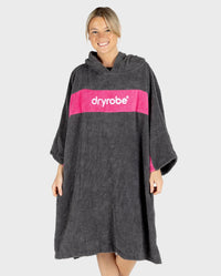 Woman smiling wearing Organic Towel dryrobe Remix in Slate Grey Pink