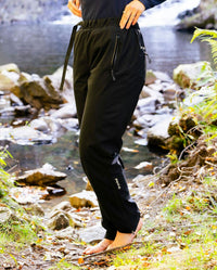 Woman stood by river wearing dryrobe® Thermal Trousers