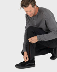 *MALE* Man kneeling down, doing up zip on leg of dryrobe® Thermal Trousers