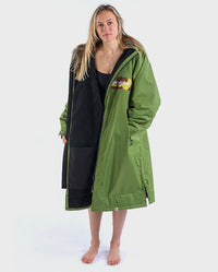 Woman wearing dryrobe Advance Long Sleeve REMIX Range change poncho in Forest Green Black Camo