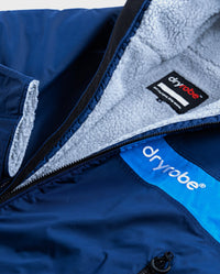 Close up of logo on dryrobe Advance Long Sleeve REMIX Range change poncho in Navy Grey Cobalt 