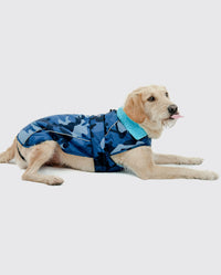 Dog lying down with tongue stuck out, wearing dryrobe Dog in Blue Camo 