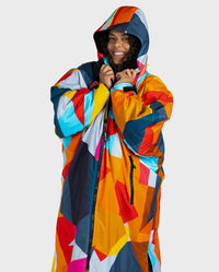 Woman wearing dryrobe Advance Abstract changing poncho with hood and zip up 
