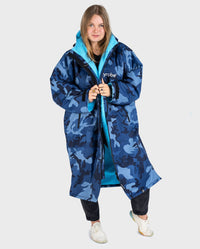 Woman wearing dryrobe Advance Long Sleeve change poncho in Blue Camo Blue 