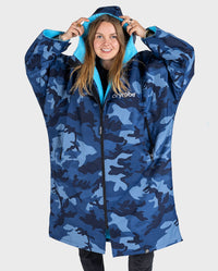 Woman pulling up hood on dryrobe Advance Long Sleeve change poncho in Blue Camo Blue