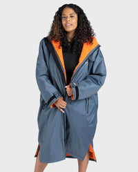 Woman wearing dryrobe Advance Long Sleeve change poncho in Dark Grey Orange