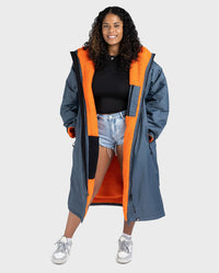 Woman wearing dryrobe Advance Long Sleeve change poncho in Dark Grey Orange