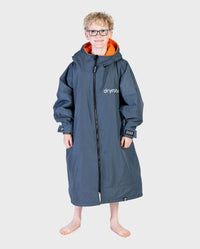 Boy wearing dryrobe Advance Long Sleeve Changing poncho in Dark Grey Orange 