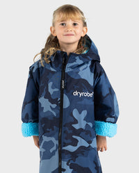 Girl wearing dryrobe Advance Long Sleeve Changing poncho in Blue Camo Blue with ends of sleeves rolled up