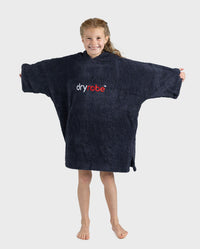 Girl wearing Organic Towel dryrobe in Navy holding arms out to the side 