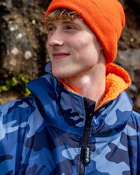 **MALE** Close up of man smiling wearing  orange dryrobe beanie and Blue Camo Orange dryrobe advance long sleeve changing robe