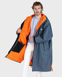 **MALE** Man wearing dryrobe Advance Long Sleeve change poncho in Dark Grey Orange showing the inner lining 