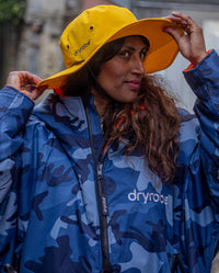 Woman wearing Yellow dryrobe Quick Dry Brimmed Hat and dryrobe Advance in Blue Camo