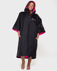 1|Woman wearing Black Pink dryrobe® Advance Short Sleeve with hood and zip up