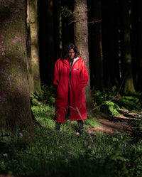 1|Woman walking through woods, wearing Red Grey dryrobe® Advance Long Sleeve